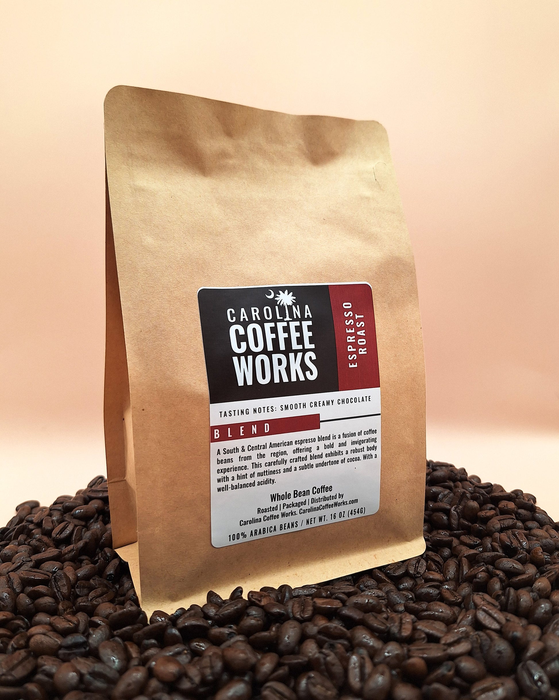 A bag of Carolina Coffee Works espresso roast, on top of a pile of specialty coffee beans.