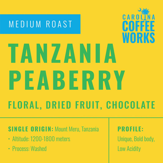 Label for Carolina Coffee Works Tanzania Peaberry Medium Roast Coffee sourced from Tanzania with floral, dried fruit, and chocolate flavor notes.