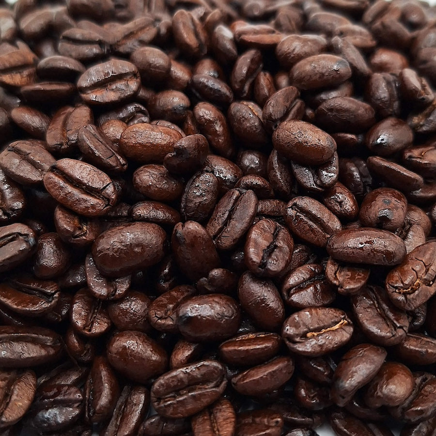 A closeup of dark roasted coffee beans.