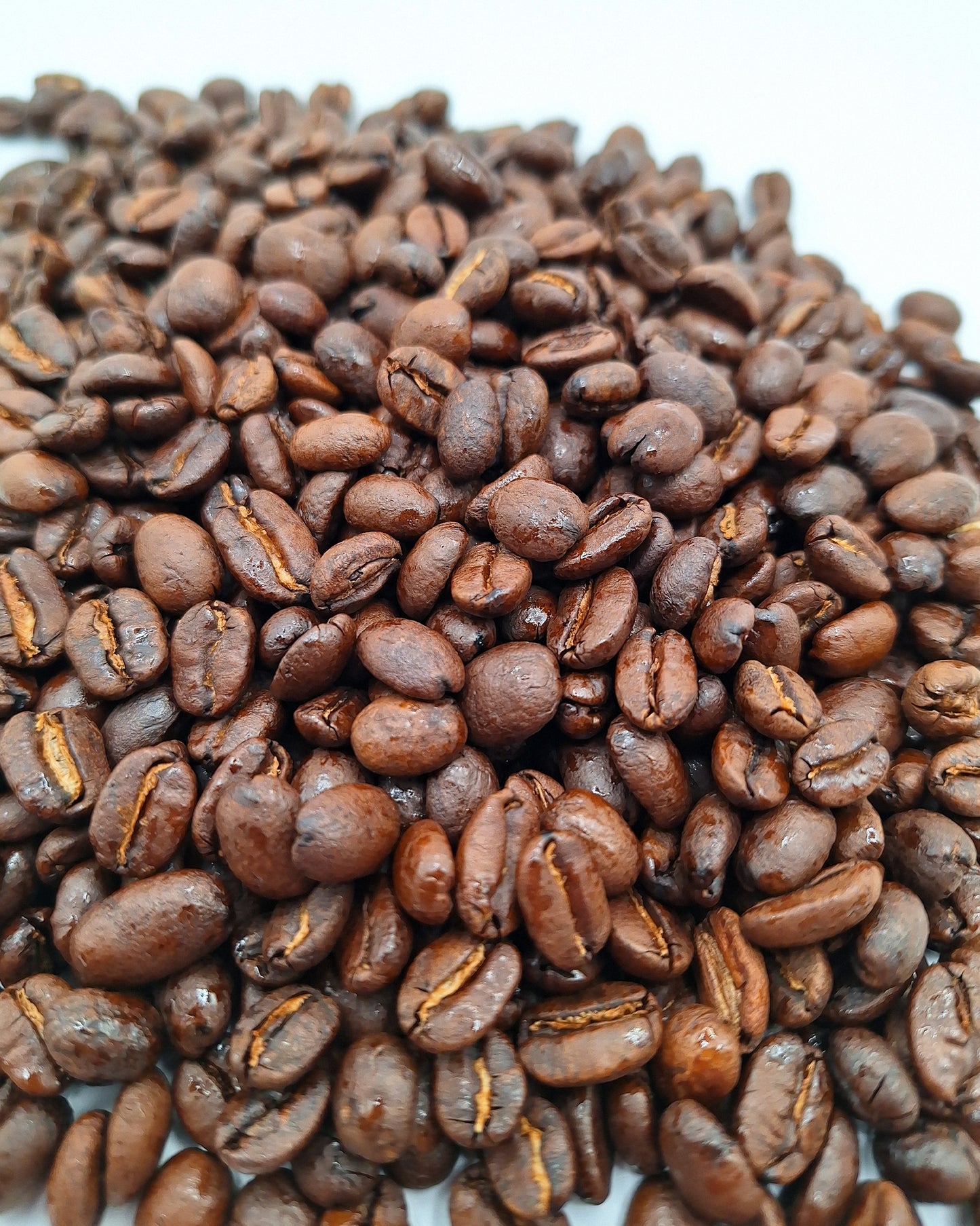 A closeup of bourbon infused flavored coffee beans. 