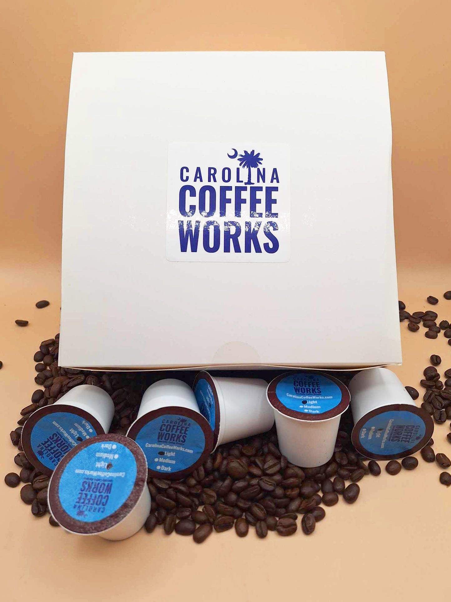 A batch of Carolina Coffee Works K Cups next to their box.